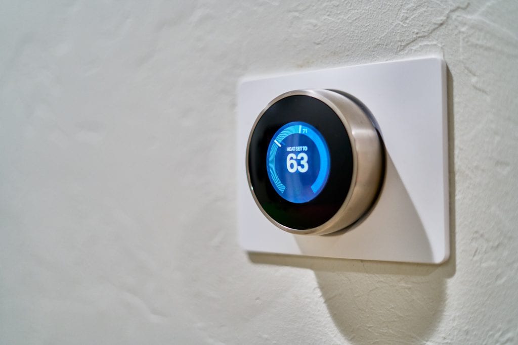 Nest thermostat on a grey wall